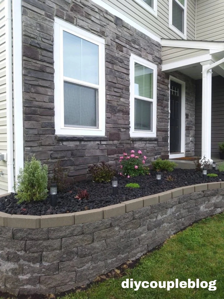 black lava rocks in our raised flower bed