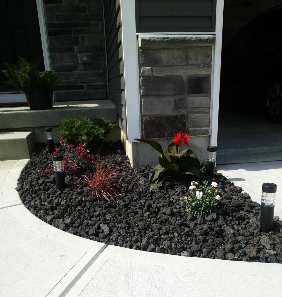 small walk way after photo with black lava rock and some perennials we planted