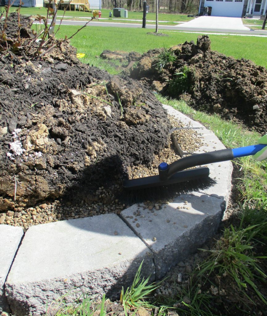 sweep off excess pea gravel on top of concrete stone 