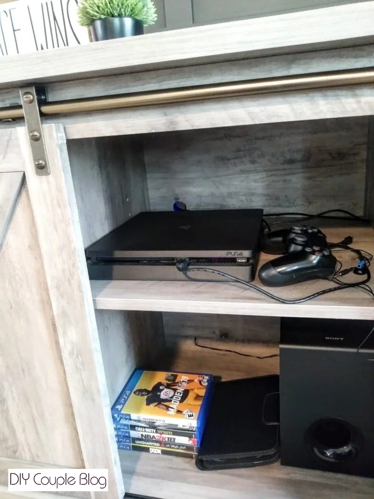 hidden gaming console, games and electronics in the new TV stand
