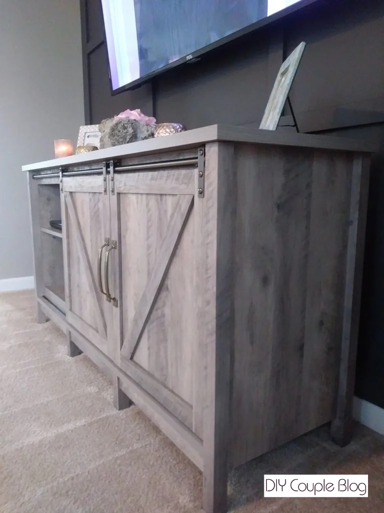 side view of the new tv stand with Tv mounted above and wires hidden in the wall