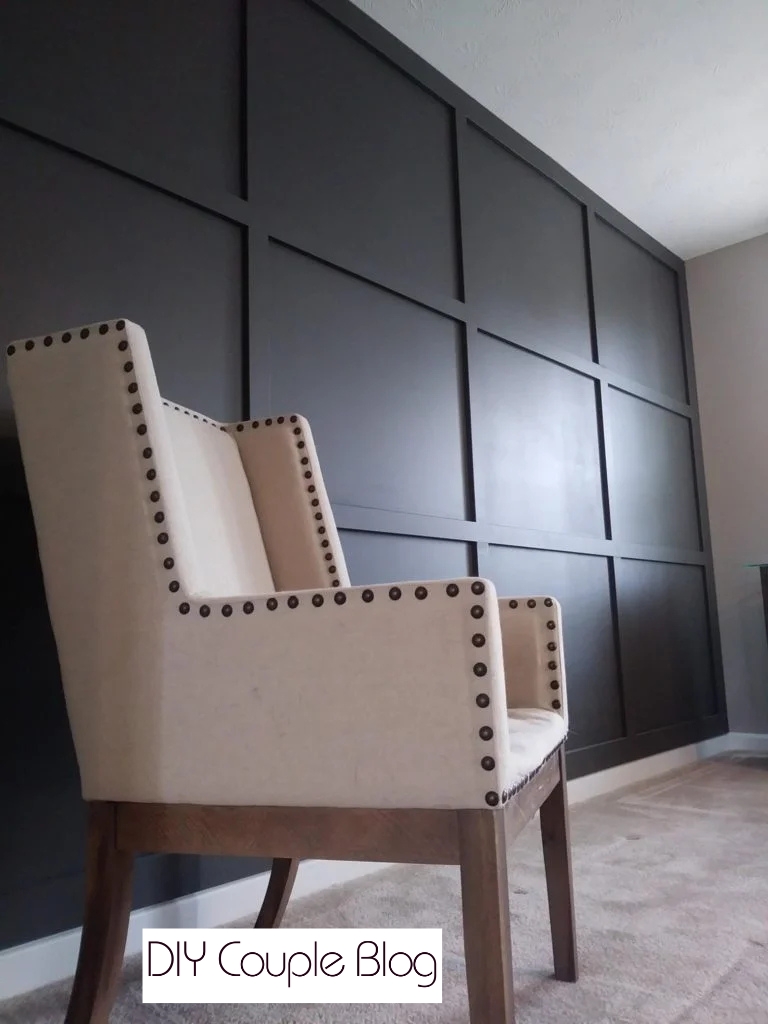 dark grey grid accent wall adds texture to living room space. 