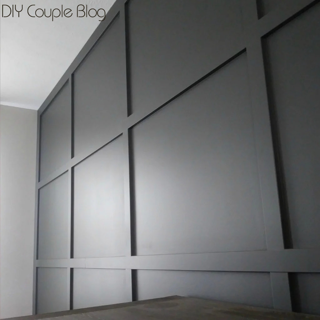 board and batten full wall completion with charcoal paint color urban bronze in the living room