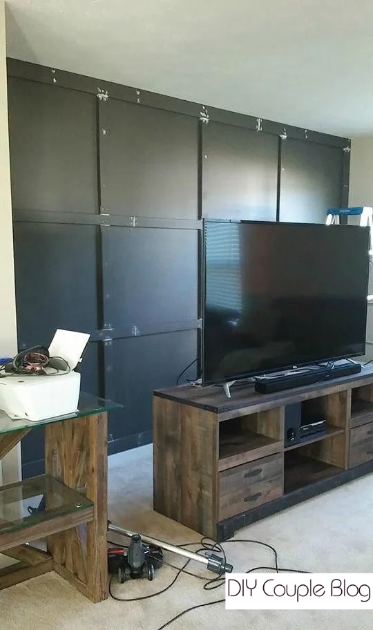 dark living room accent wall behind tv with caulked and painted board and batten joints