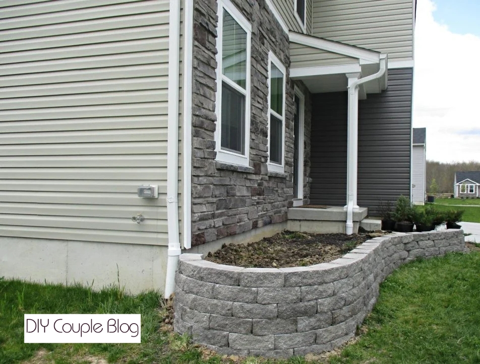 prepping the final row for a finishing top paver cap on a stone wall