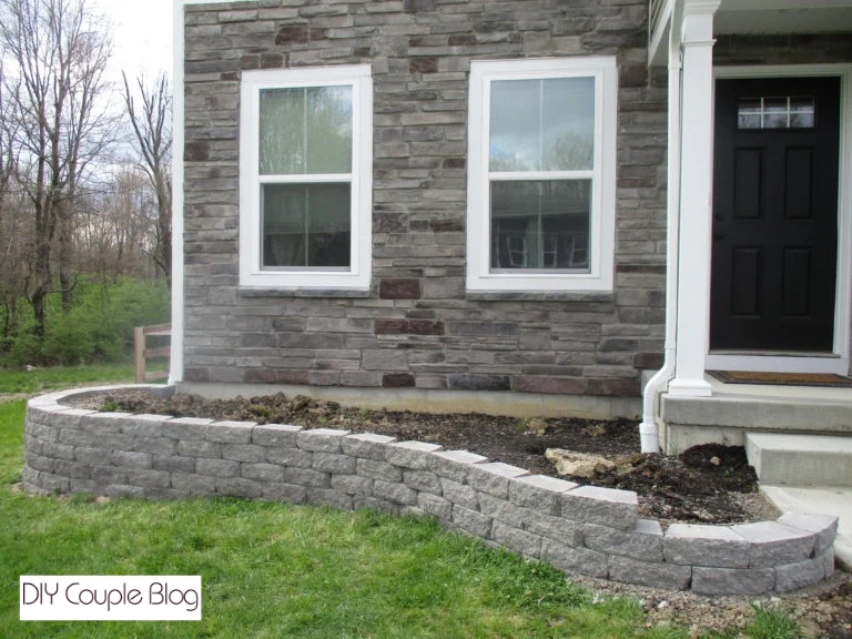 gray stone wall blocks holding back a raised flower bed
