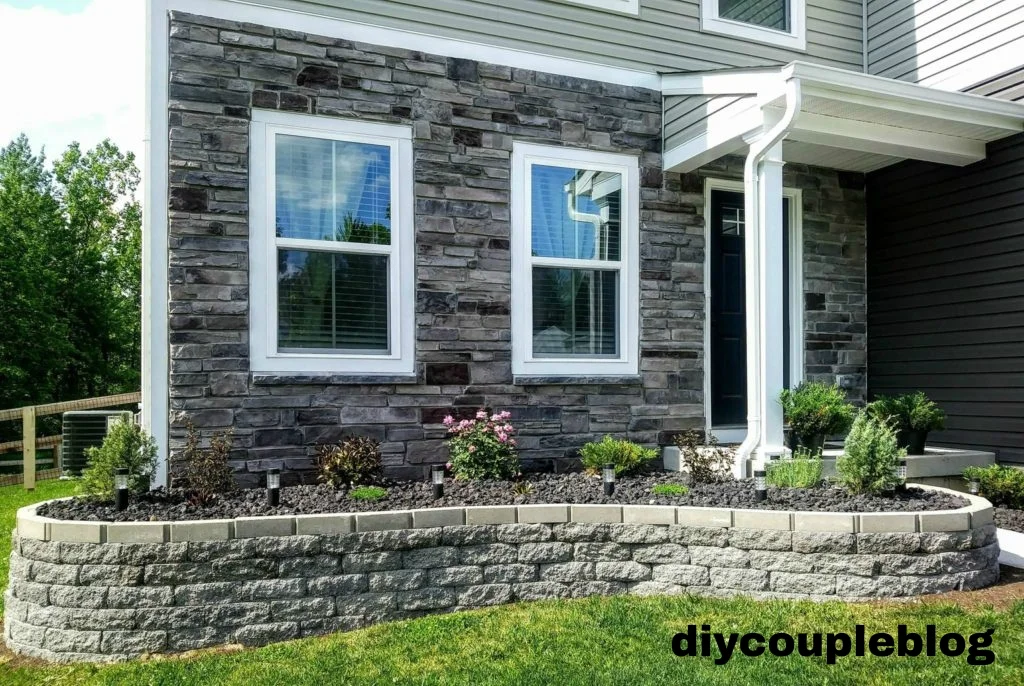 the final look at using stone for a retaining wall on our front yard raised flower bed for landscaping curb appeal 