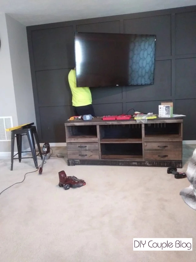 homeowner working behind the television