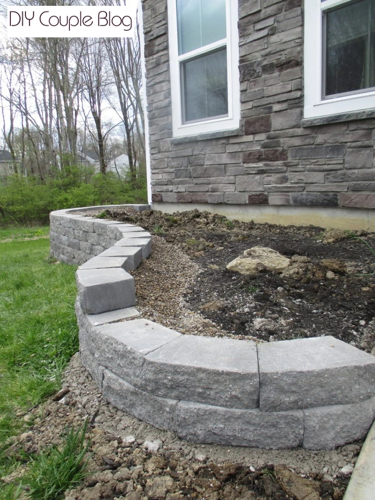 continuing stacking garden wall blocks in our front yard raised flower bed 