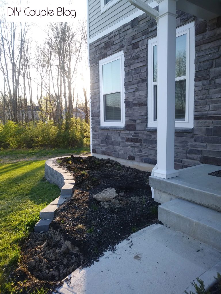 making progress on a retaining wall in our front yard flower bed