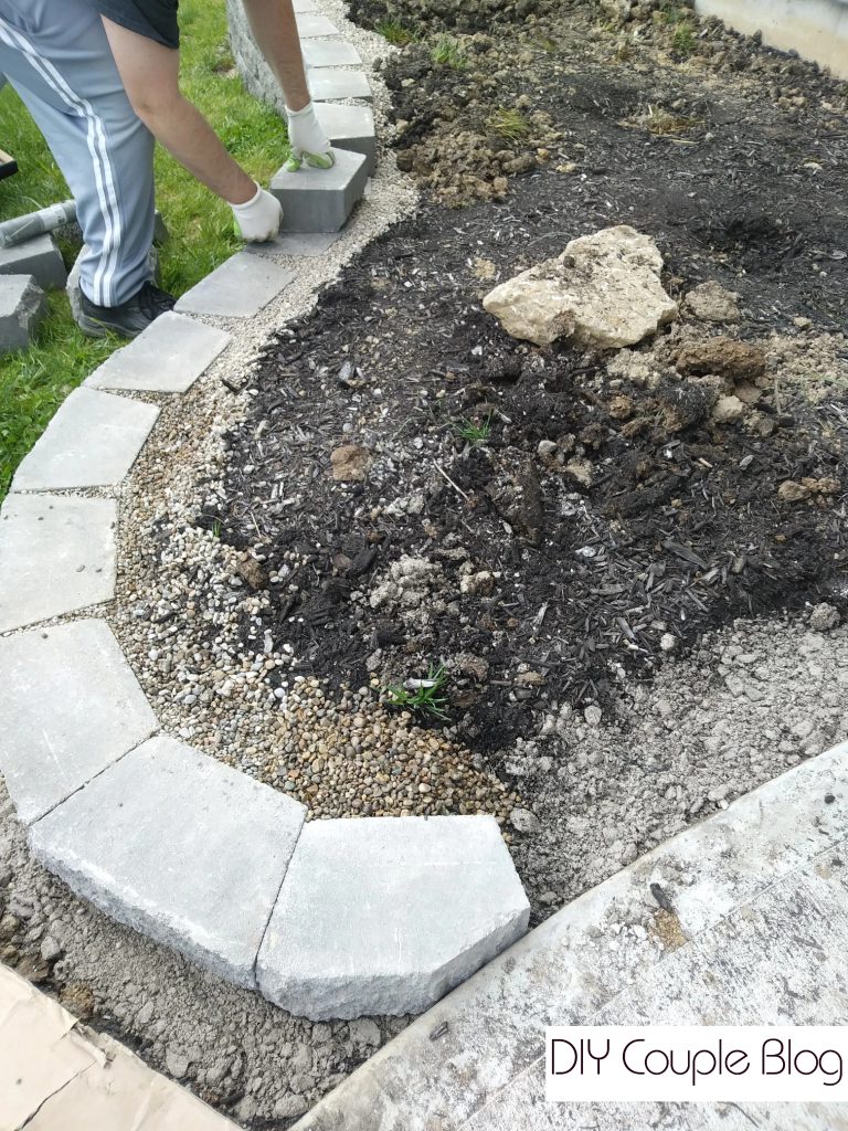 a close-up of landscaping with a stone retaining wall for curb appeal