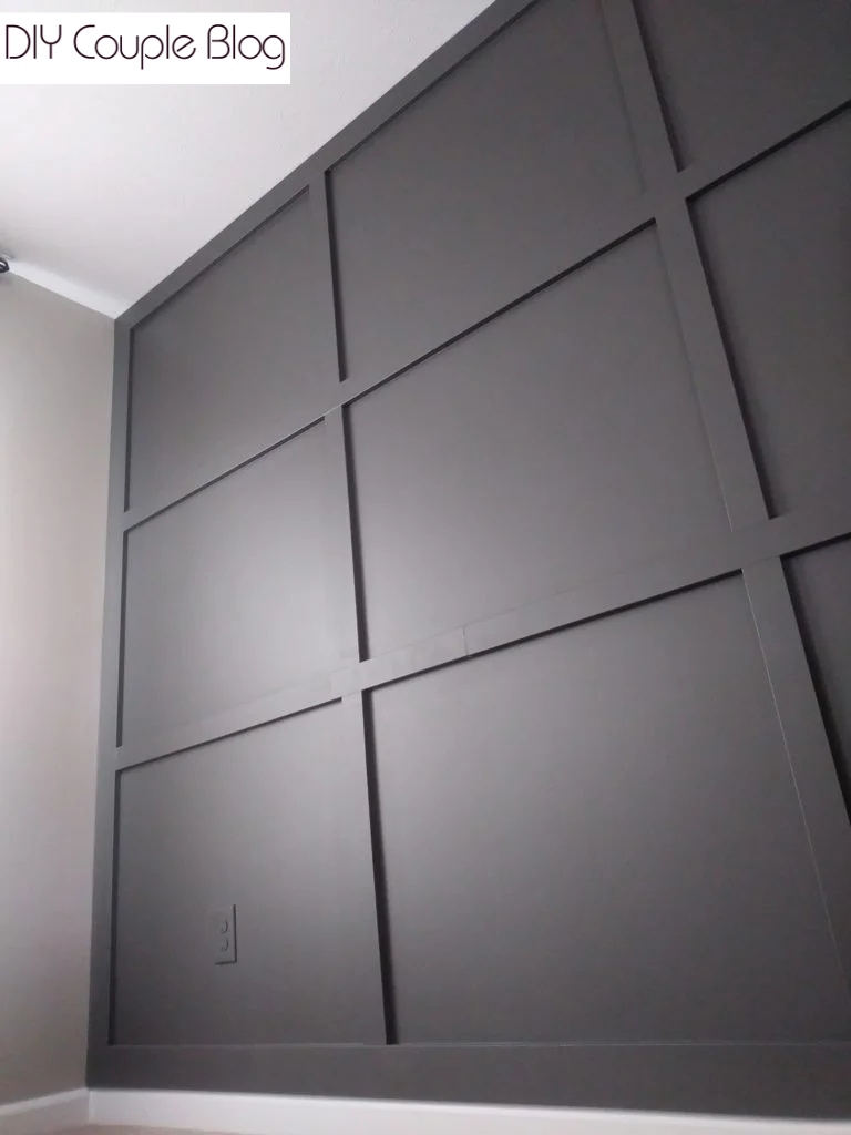 floor to ceiling dark charcoal paint grid wall board and batten 