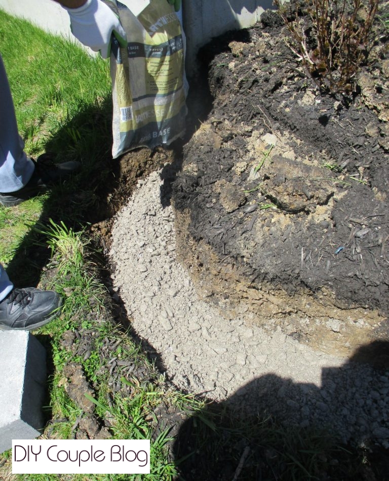 pouring paver base before installing the first-row foundation of our block retaining wall