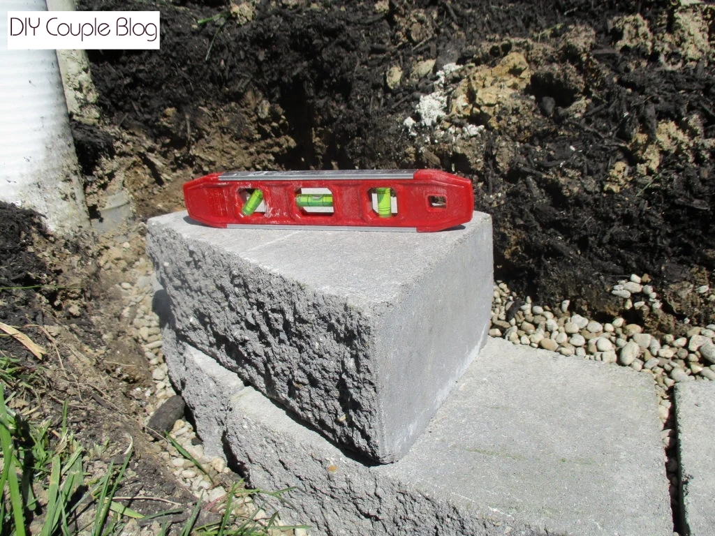 leveling the second row of stone retaining wall block  