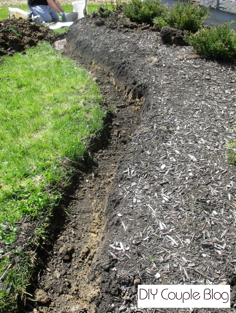 showing a dug trench in our dirt prepping for a DIY retaining wall