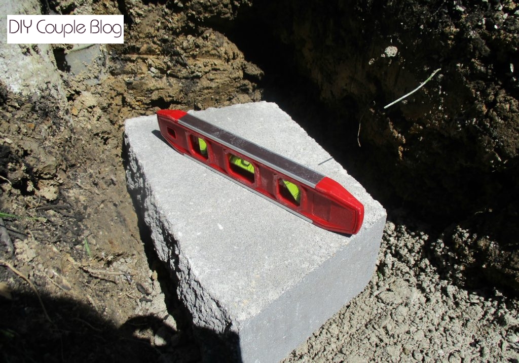 leveling the first stone for the base of wall