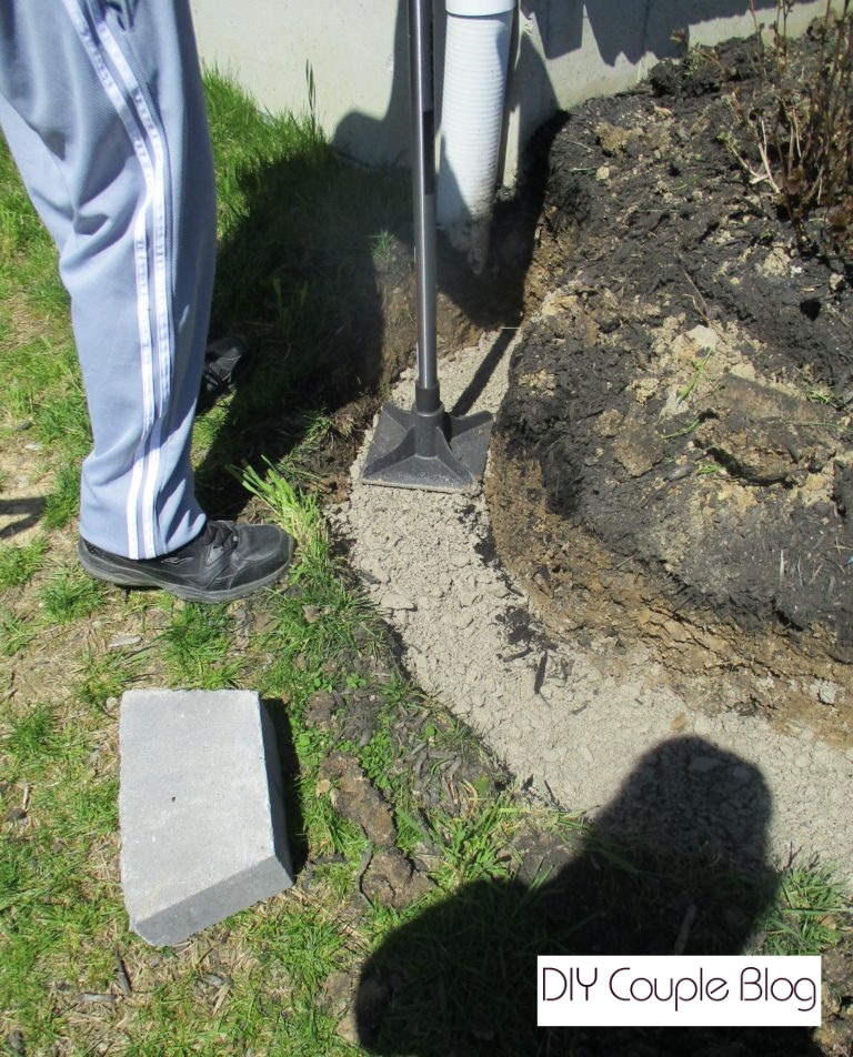 tamping the paver base down for a flat level base