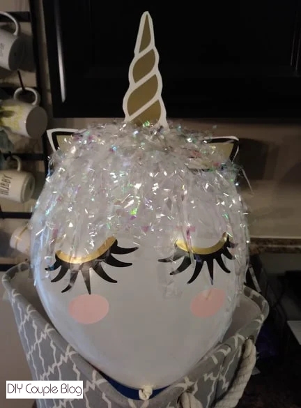unicorn balloon craft with decorative shred, dollar store decal, and latex balloon