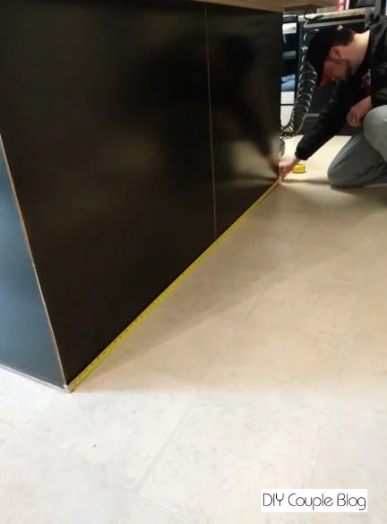 measuring the length of the kitchen island 