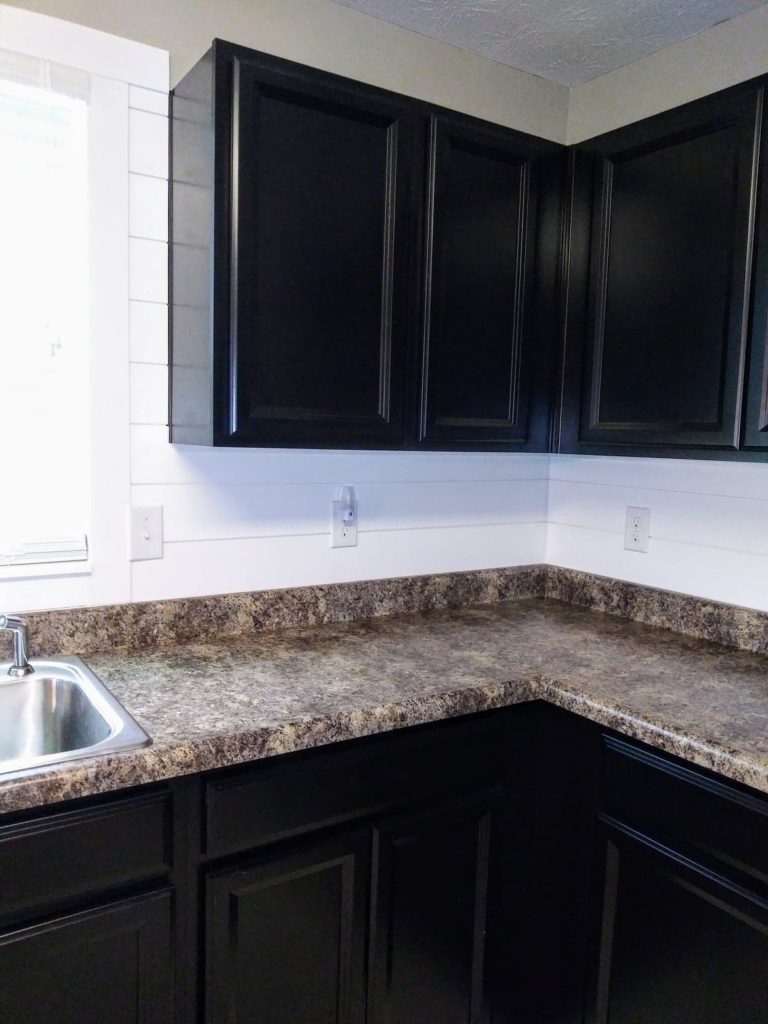 white shiplap kitchen backsplash dark cabinets