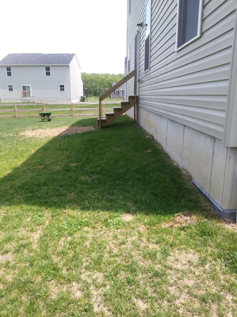 before photo of the backyard with steps