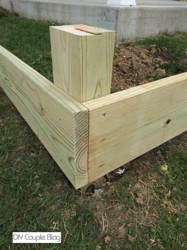 close-up of attaching the corners while keeping them level to build wood raised beds