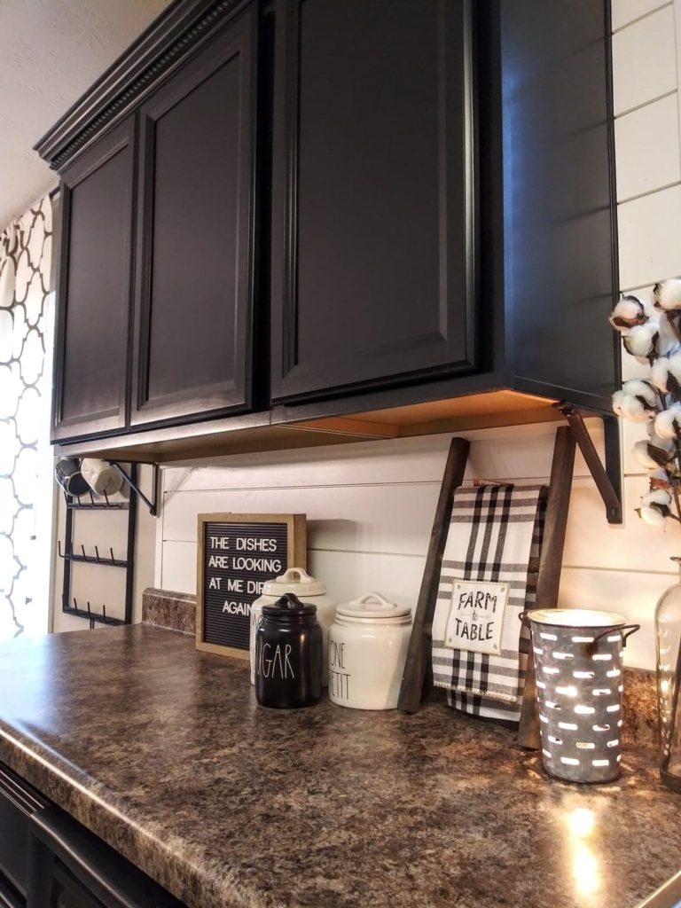 black kitchen cabinets with shiplap backsplash