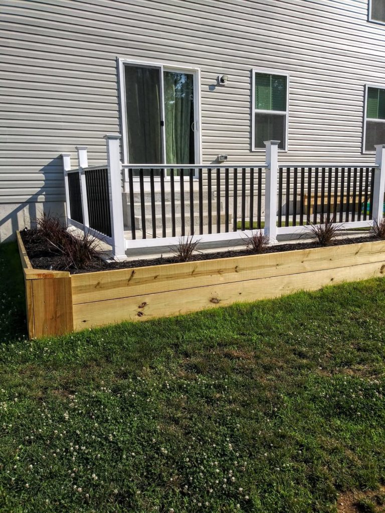 front view of raised garden around patio