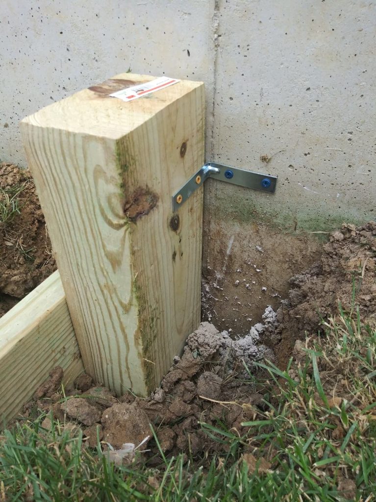 mounting the wood post to the house foundation