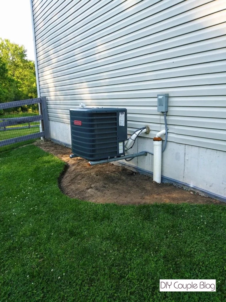 removing the top layer of grass around our ac unit