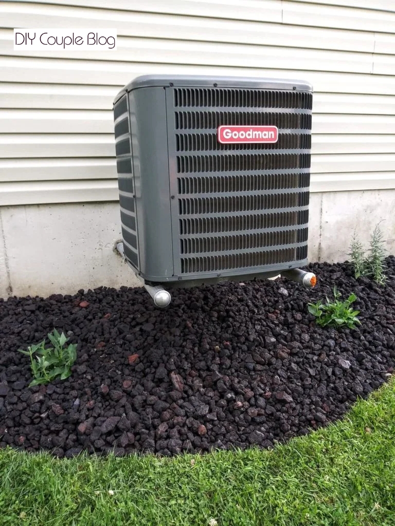 the finished view of using lava rock for landscaping around our air conditioner unit