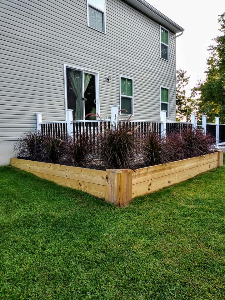 raised garden bed around concrete patio with privacy