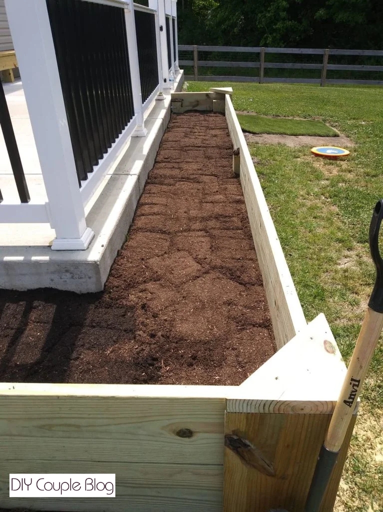 filling our raised garden beds with topsoil
