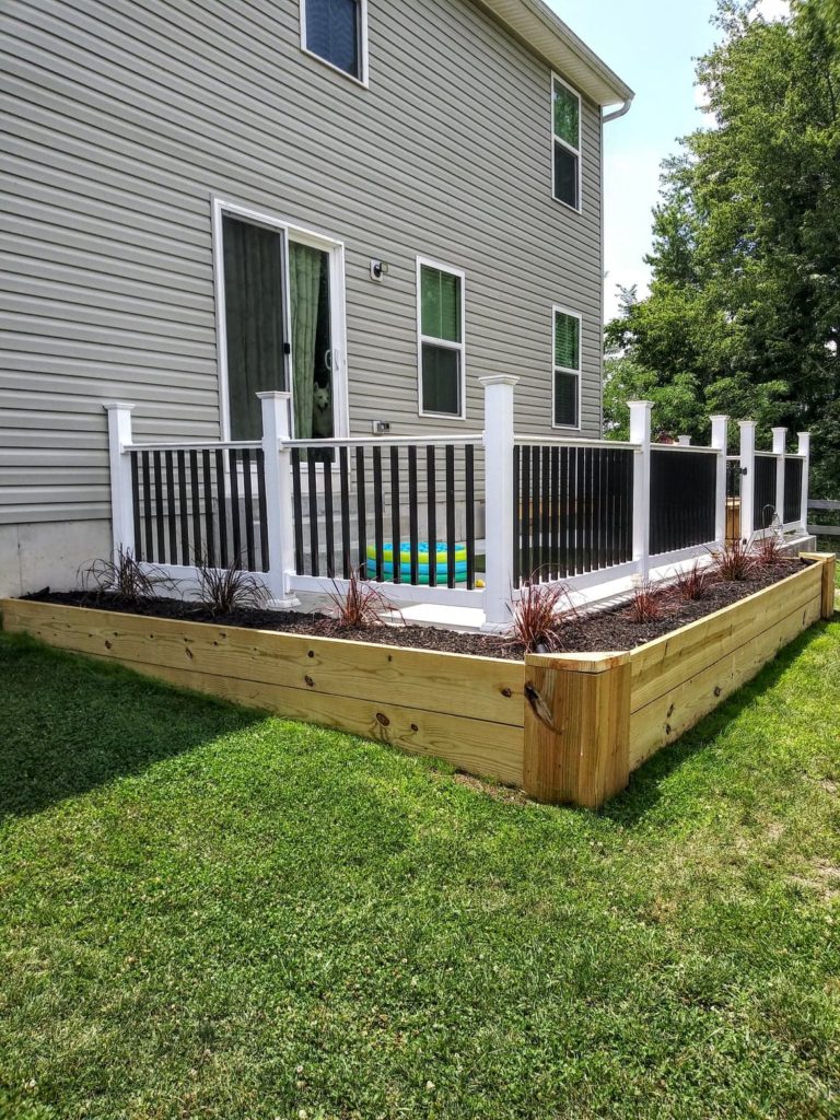 raised garden bed around patio the after photo