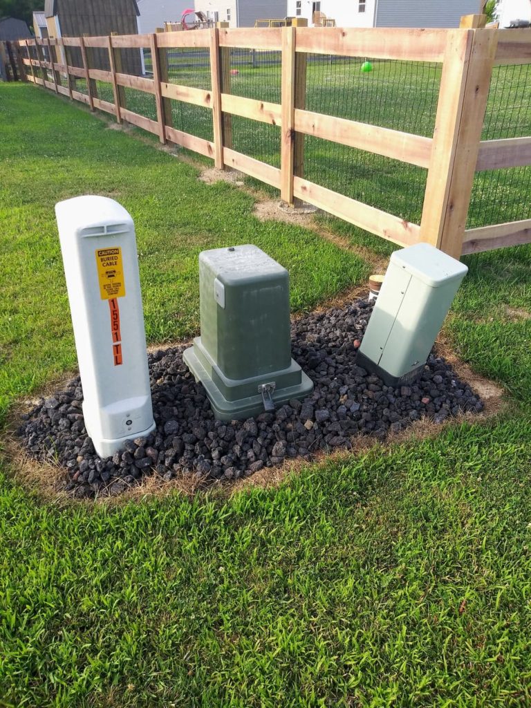 hide utility box with black lava rock