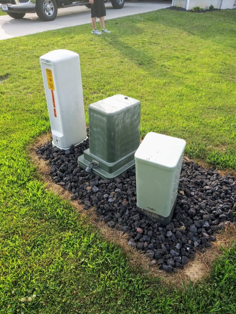 landscape around utility box with rock