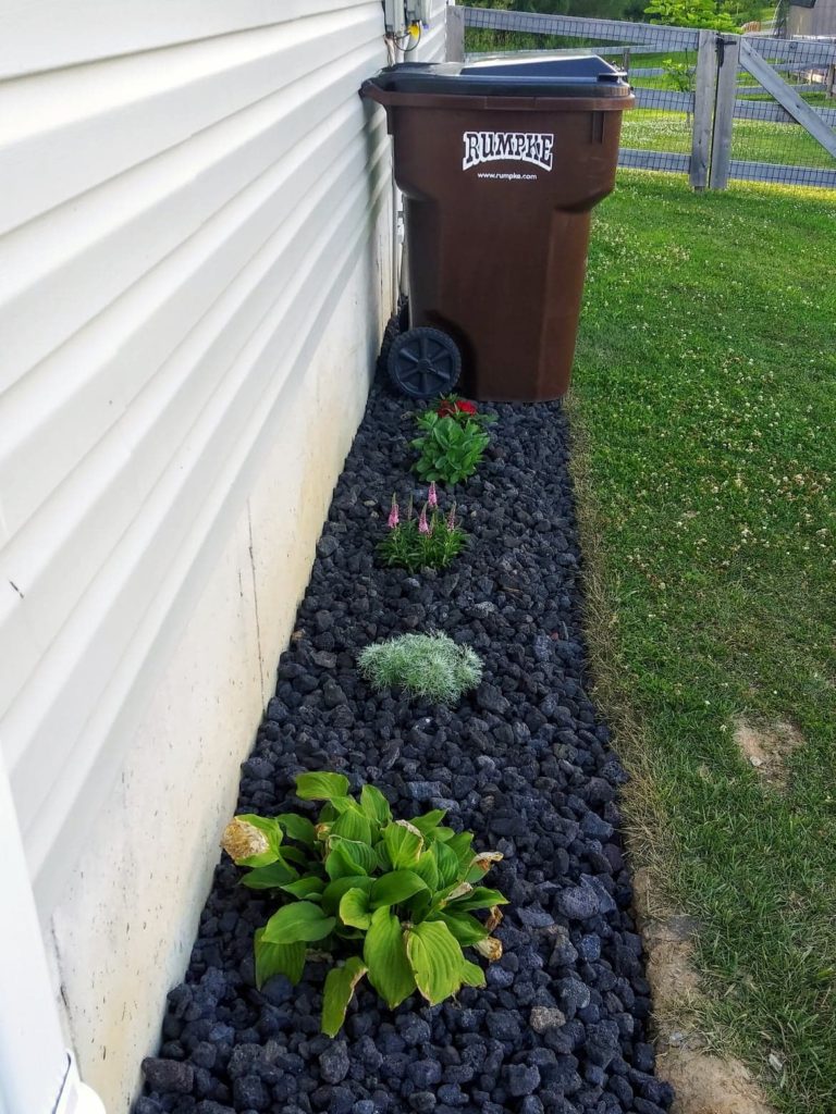 hid garage can with pretty landscaping 