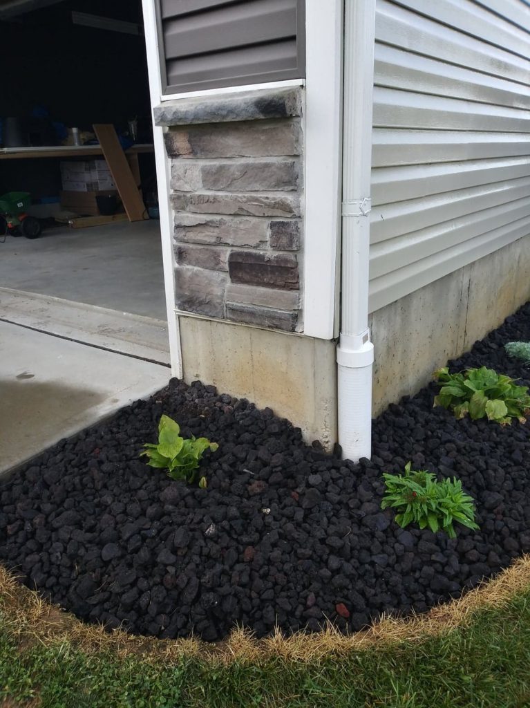 landscaping on side of house wrapping to front of garage