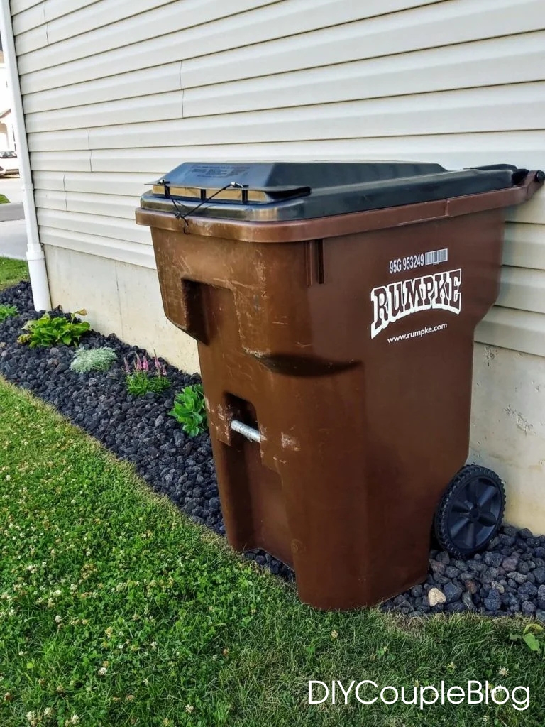 prettying up the side of the house with the garbage can with some easy rock landscaping