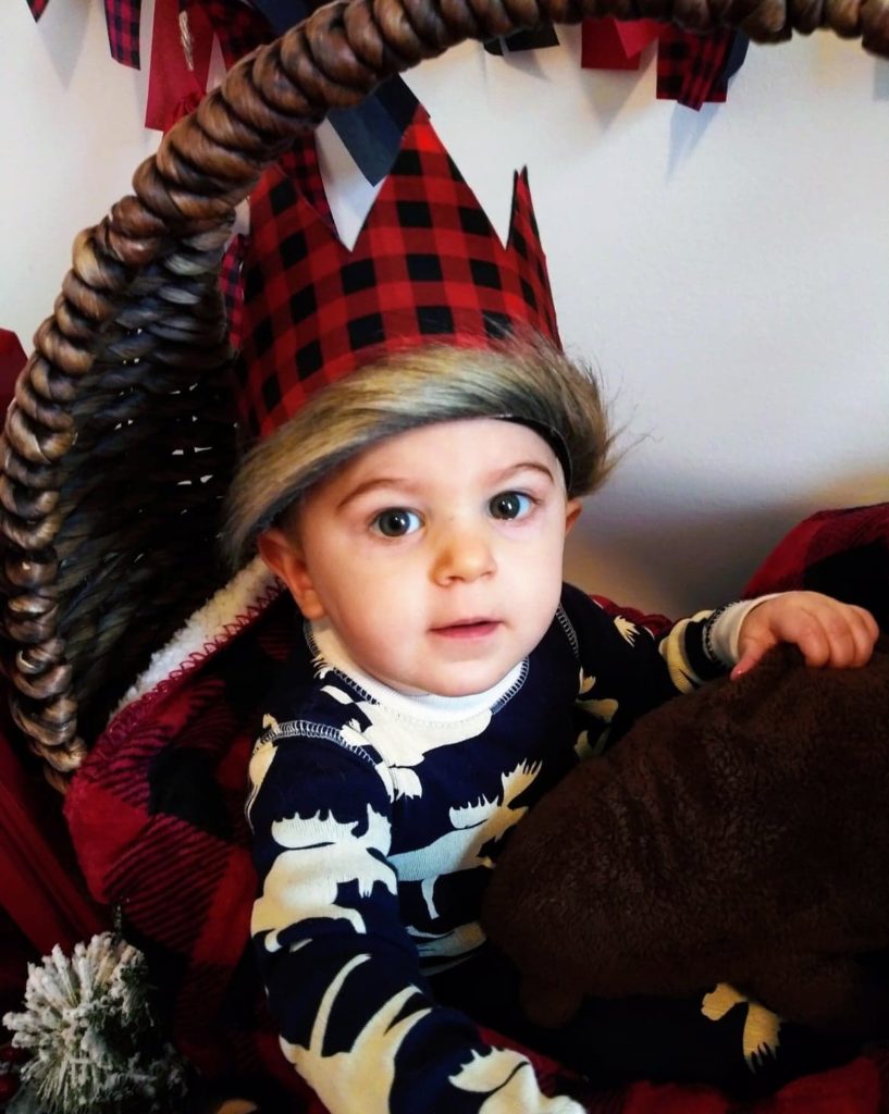 posing in a basket with his crown