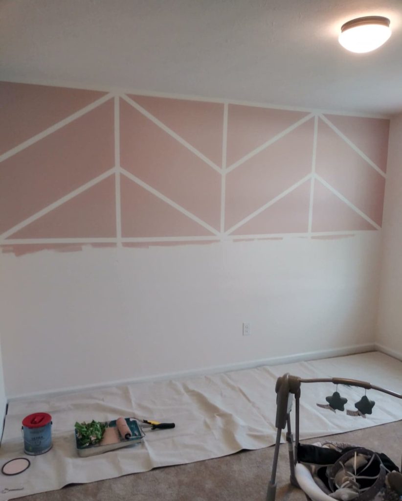 girl nursery with pink herringbone wall