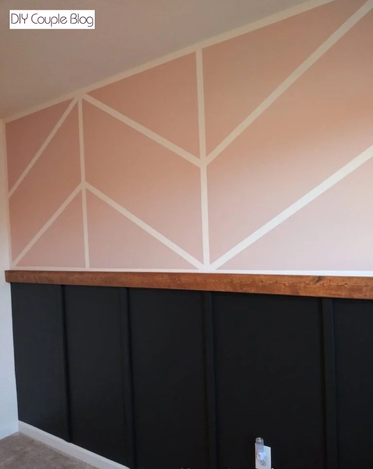 upper half painted pink wall with a lower half board and batten nursery