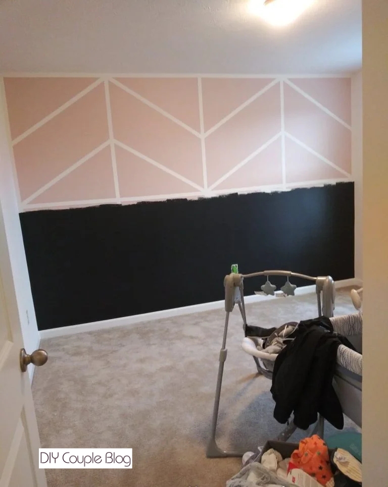 painted nursery wall for girl using pink paint for the upper half and tricorn black for the bottom half