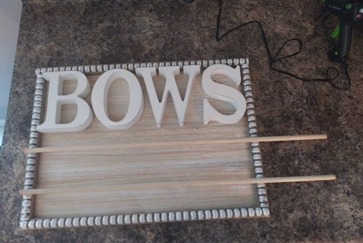 baby bow sign with letters and rods in place