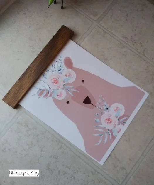 sandwiching the woodland animal print between the wood strips