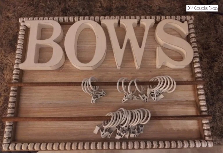 clips slid on and wood dowels glued down and letters that spell "bows" for a craft project