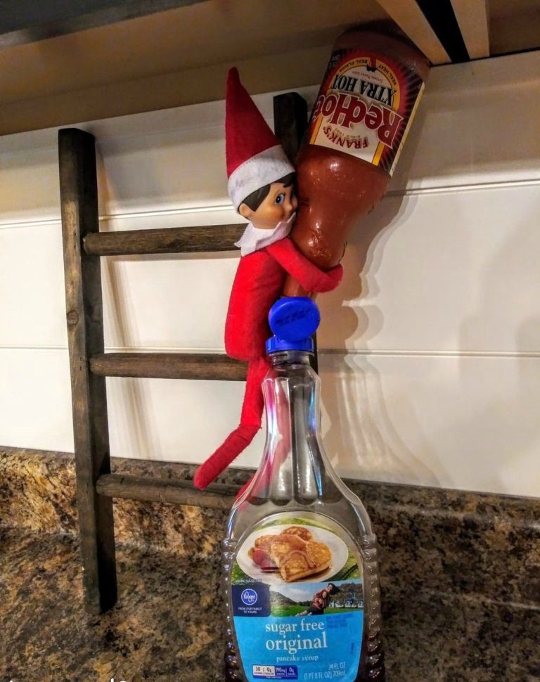 naughty elf on the shelf putting hot sauce in pancake syrup