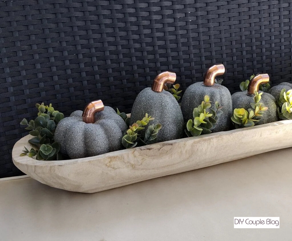 pumpkins, greenery staged in a dough bowl for a farmhouse chic fall centerpiece 