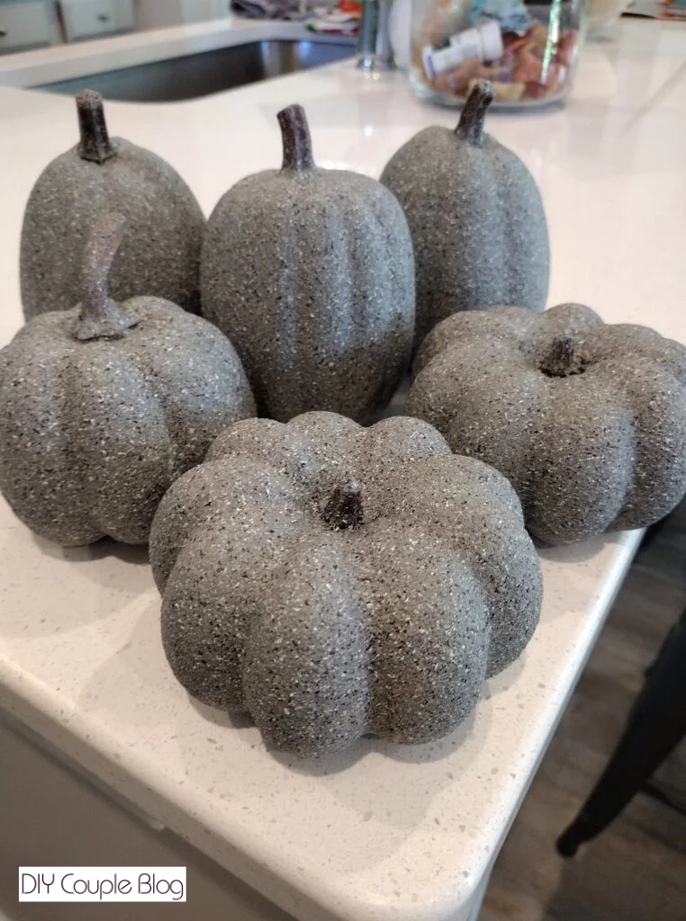 DIY pumpkins painted in stone spray paint to look like faux concrete