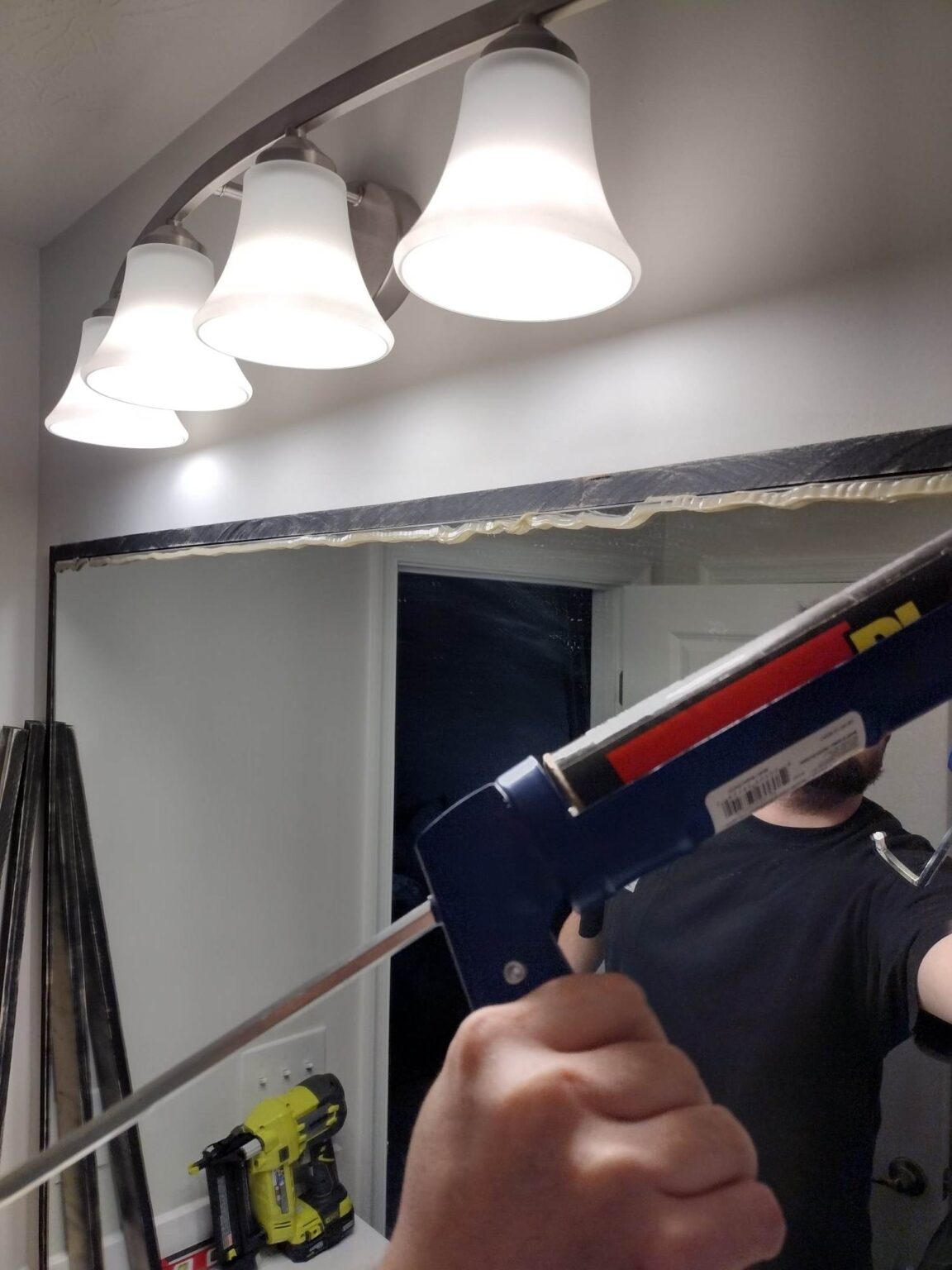 DIY Bathroom Mirror Frame (How We Upgraded Our Basic Builder Grade Mirror) - DIY Couple Blog